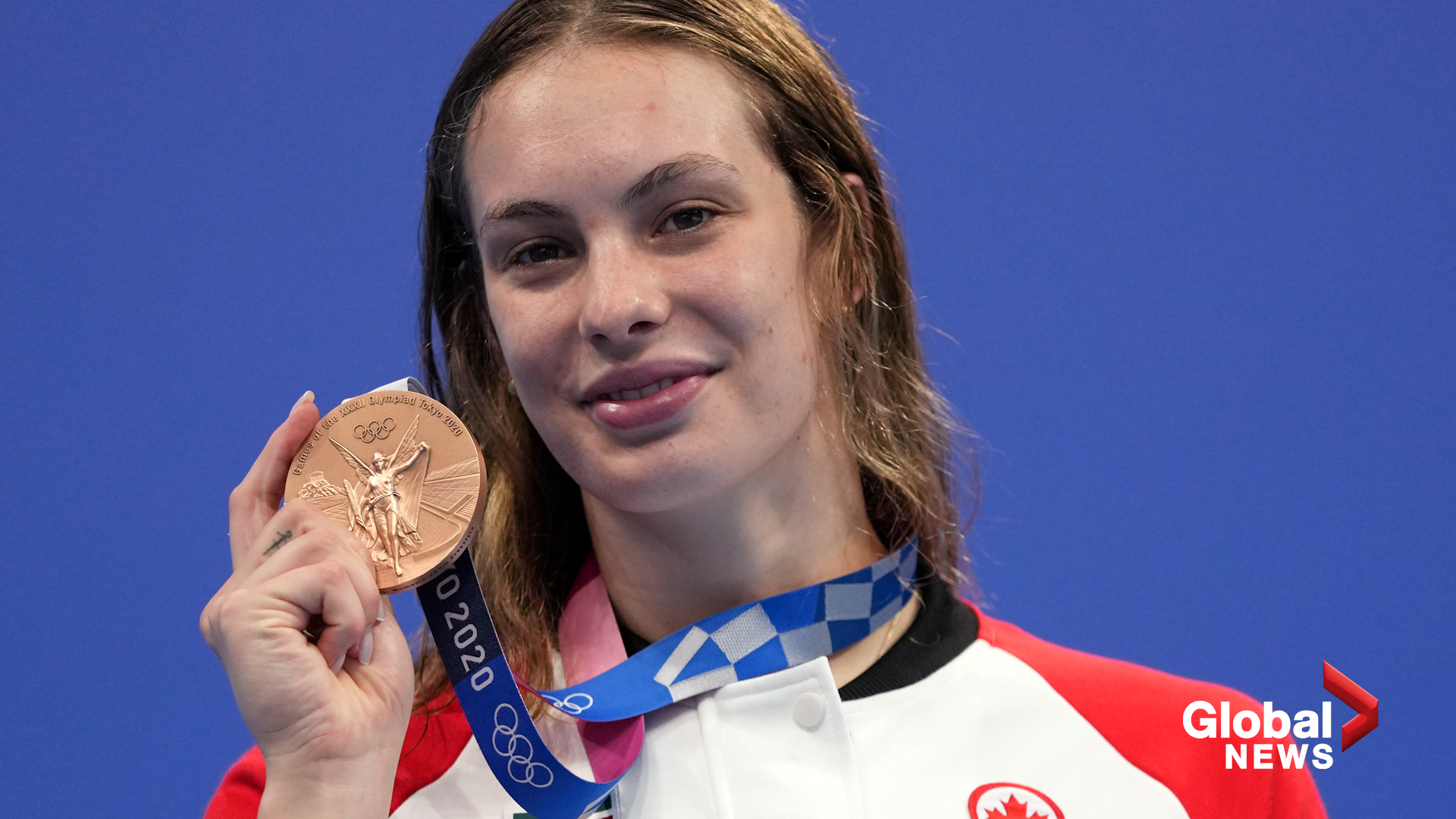 Canada's most decorated Olympian struggled to untangle her 7 medals while  on camera at an NHL game